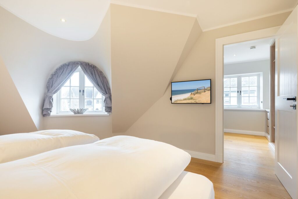 Schlafzimmer in Ferienwohnung Wenningstedt