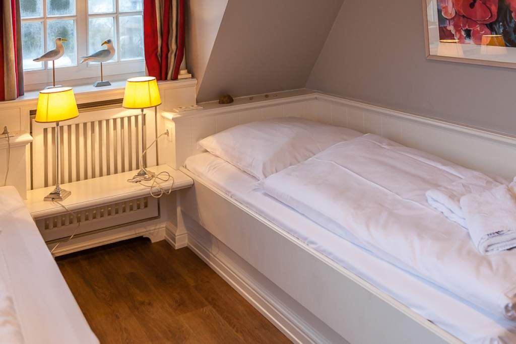 Schlafzimmer in Ferienwohnung Wenningstedt