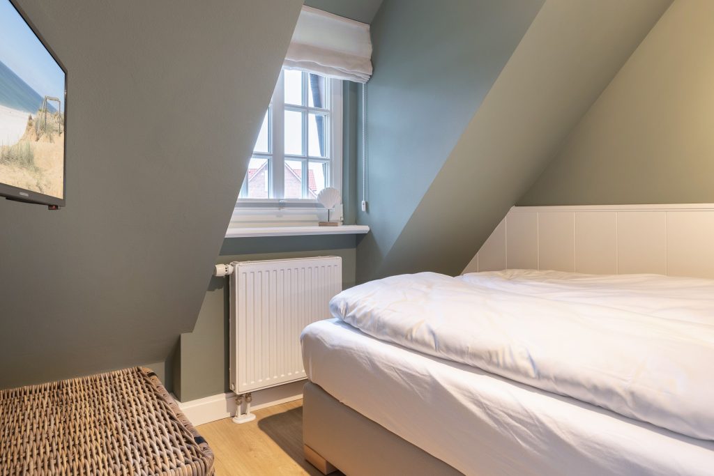 Schlafzimmer in Ferienwohnung Wenningstedt
